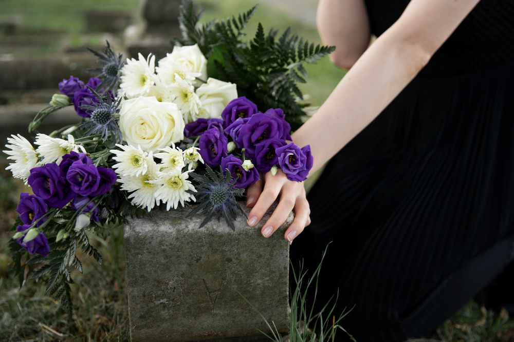 close up woman visiting grave loved one